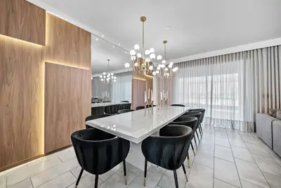 a dining room with a table and black chairs at Brand NEW Home 09 BedroomsPoolGame Room in Kissimmee
