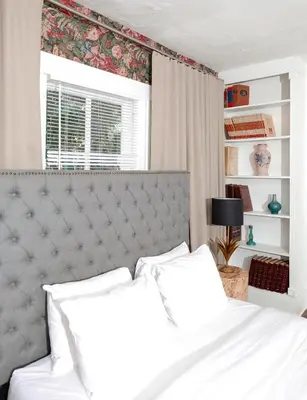 a bedroom with a white bed and a window at Norment Parry by The Wellborn in Orlando