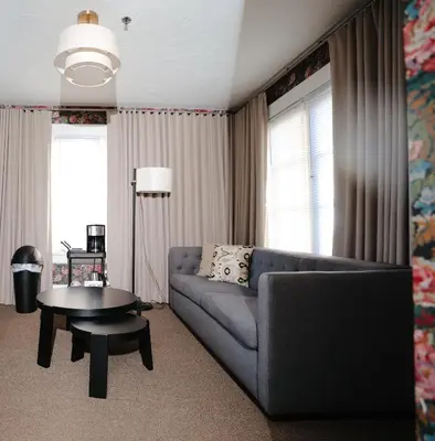 a living room with a couch and a table at Norment Parry by The Wellborn in Orlando