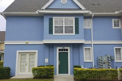 a blue house with a green door at True Fantasies 101 in Kissimmee