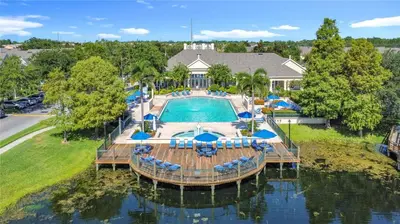 an overhead view of a swimming pool with a deck and chairs at True Fantasies 101 in Kissimmee
