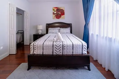 a bedroom with a bed with a white bedspread at Spacious Orlando Getaway Vacation Home in Orlando