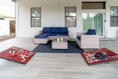 a living room with a blue couch and some rugs at Spacious Orlando Getaway Vacation Home in Orlando