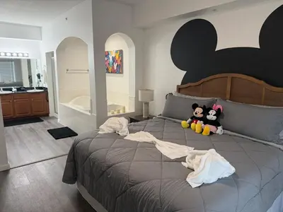 a bedroom with a large bed with two stuffed animals on it at Magical Condo 3 bedroom in Orlando