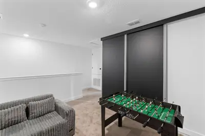 a living room with a foosball table and a couch at Elegant Home near Disney - pool - free parking in Kissimmee
