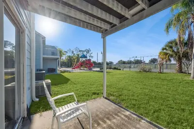 a white bench sitting on the porch of a house at Near Disney! Pool and Hot Tub with Free Parking in Kissimmee
