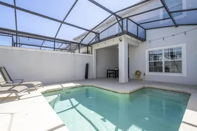 a swimming pool in a house with a glass ceiling at Townhome 4Q c/ Piscina Privativa – Storey Lake in Kissimmee