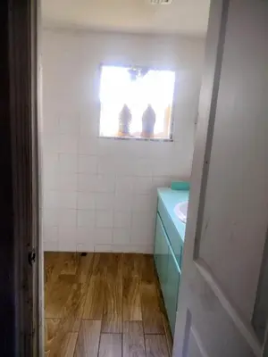 a small bathroom with a sink and a window at A great environment living space in Orlando
