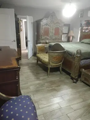 a bedroom with a bed and a desk and chairs at A great environment living space in Orlando