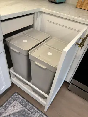 an open refrigerator with two trash cans at Parks2Coast Trail Casita in Sanford