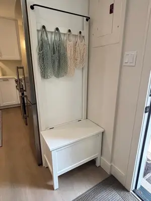 a white refrigerator with hangers in a room at Parks2Coast Trail Casita in Sanford