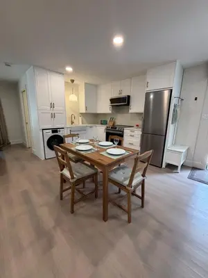 a kitchen with a wooden table and chairs in a kitchen at Parks2Coast Trail Casita in Sanford