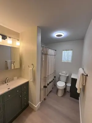 a bathroom with a toilet and a sink at Parks2Coast Trail Casita in Sanford