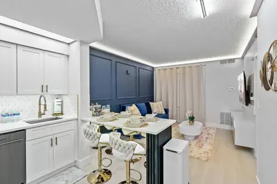 a kitchen and living room with a table and chairs at Well-Located 1BR Kitchen Near Theme Parks in Orlando