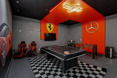 a room with a ping pong table in a garage at Large Orlando Home 8BR Great Location in Kissimmee