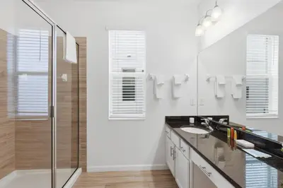 a white bathroom with a sink and a shower at Large Orlando Home 8BR Great Location in Kissimmee