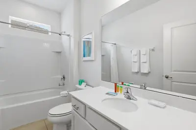 a white bathroom with a sink and a toilet at Large Orlando Home 8BR Great Location in Kissimmee
