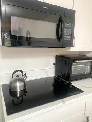 a pot sitting on a stove next to a microwave at Sea World Orlando Apts Parks Convention Centre in Orlando