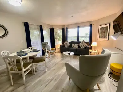 a living room with a couch and a table and chairs at Sea World Orlando Apts Parks Convention Centre in Orlando