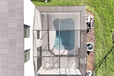 an aerial view of a building with a swimming pool at New 5BR Villa Near Disney I Resort Lazy River in Orlando
