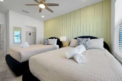 a bedroom with two beds and a ceiling fan at New 5BR Villa Near Disney I Resort Lazy River in Orlando