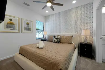 a bedroom with a bed and a ceiling fan at New 5BR Villa Near Disney I Resort Lazy River in Orlando