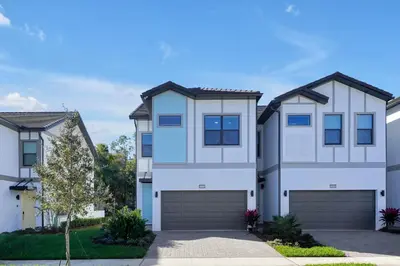 a house with a garage in front of it at New 5BR Villa Near Disney I Resort Lazy River in Orlando