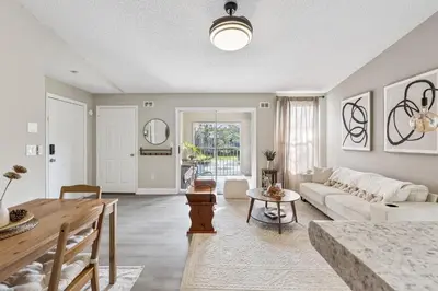 a living room with a couch and a table at Quiet Gated Condo Near Universal with Pool and View in Orlando