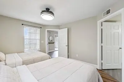 a bedroom with two beds and a window at Quiet Gated Condo Near Universal with Pool and View in Orlando