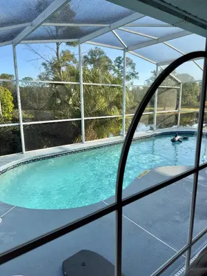 a view of a swimming pool through a window at Magic getaway in Kissimmee