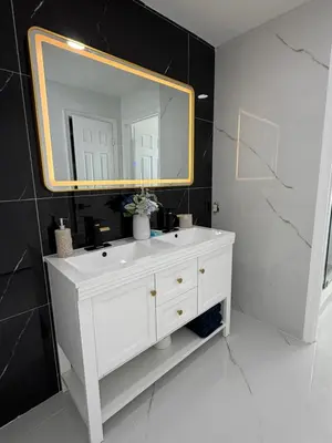 a bathroom with a white sink and a mirror at Magic Palms House 10 Min to Parks in Kissimmee