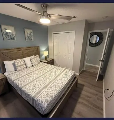 a bedroom with a bed and a ceiling fan at TownHouse at Emerald Island Resort Near Disney in Kissimmee