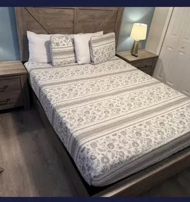 a bedroom with a large bed with a wooden headboard at TownHouse at Emerald Island Resort Near Disney in Kissimmee