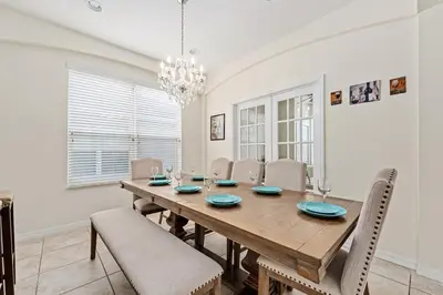 a dining room with a wooden table and chairs at Family Retreat at Lake Berkley Resort! in Kissimmee