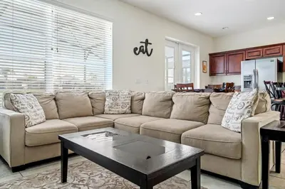 a living room with a couch and a coffee table at Family Retreat at Lake Berkley Resort! in Kissimmee
