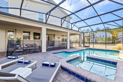 an indoor swimming pool with a glass roof at Close to Disney! Pool, Spa, Game, & Movie Room! in Kissimmee