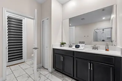a bathroom with a sink and a mirror at Close to Disney! Pool, Spa, Game, & Movie Room! in Kissimmee