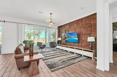 a living room with a couch and a table at Lakefront | Sleeps 18 | 8-Bed Villa w/ Pool & Epic in Kissimmee
