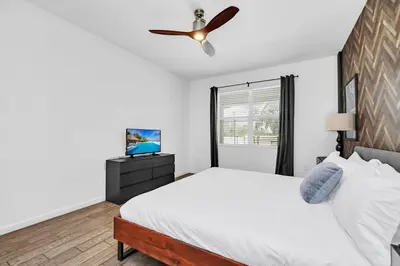 a bedroom with a bed and a ceiling fan at Lakefront | Sleeps 18 | 8-Bed Villa w/ Pool & Epic in Kissimmee