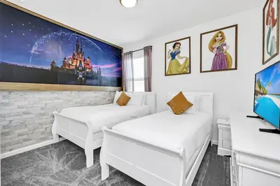 two white beds in a room with a tv at Lakefront | Sleeps 18 | 8-Bed Villa w/ Pool & Epic in Kissimmee