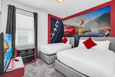 a hotel room with two beds and a tv at Lakefront | Sleeps 18 | 8-Bed Villa w/ Pool & Epic in Kissimmee
