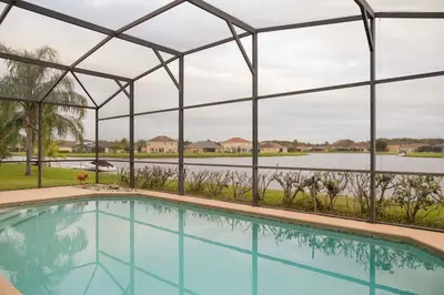 a large swimming pool with a metal structure at 5BR 4BA Pool Pool Table Near Disney in Kissimmee