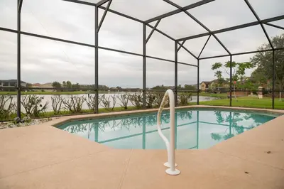 a swimming pool in a tent with a view of the water at 5BR 4BA Pool Pool Table Near Disney in Kissimmee