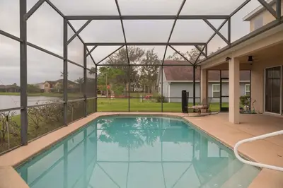a swimming pool in a house with a glass roof at 5BR 4BA Pool Pool Table Near Disney in Kissimmee