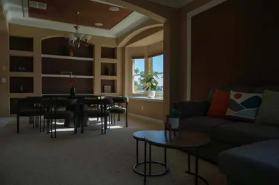 a living room with a couch and a table and chairs at 5BR 4BA Pool Pool Table Near Disney in Kissimmee