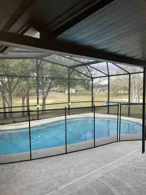 a swimming pool in a building with a glass wall at Dream Getaway Nr Disney! Own Pool & Modern Feel! in Orlando