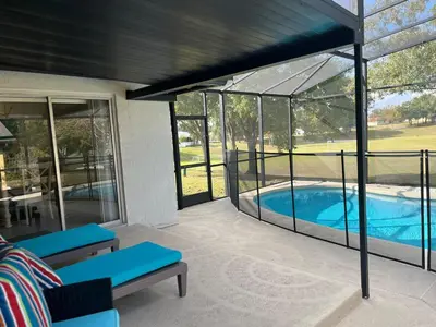 a screened in porch with a swimming pool at Dream Getaway Nr Disney! Own Pool & Modern Feel! in Orlando