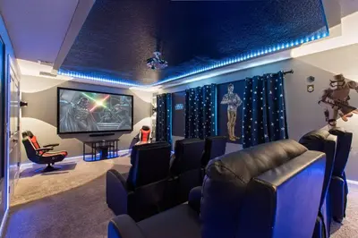 a room with a cinema with chairs and a tv at Close to Disney! Pool/Spa/Game & Movie room! in Kissimmee