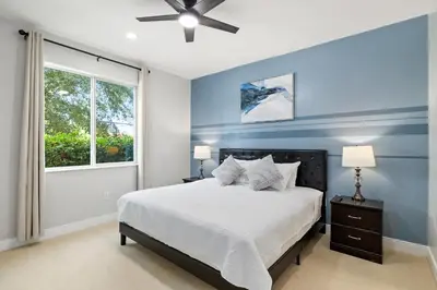 a bedroom with a large bed and a window at Villa near Orlando's Attractions in Orlando