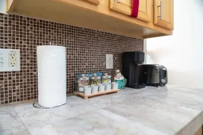 a kitchen with a counter with a coffee maker and a microwave at Gated Pool Home 20 Min to Disney, Uni, MCO in Kissimmee